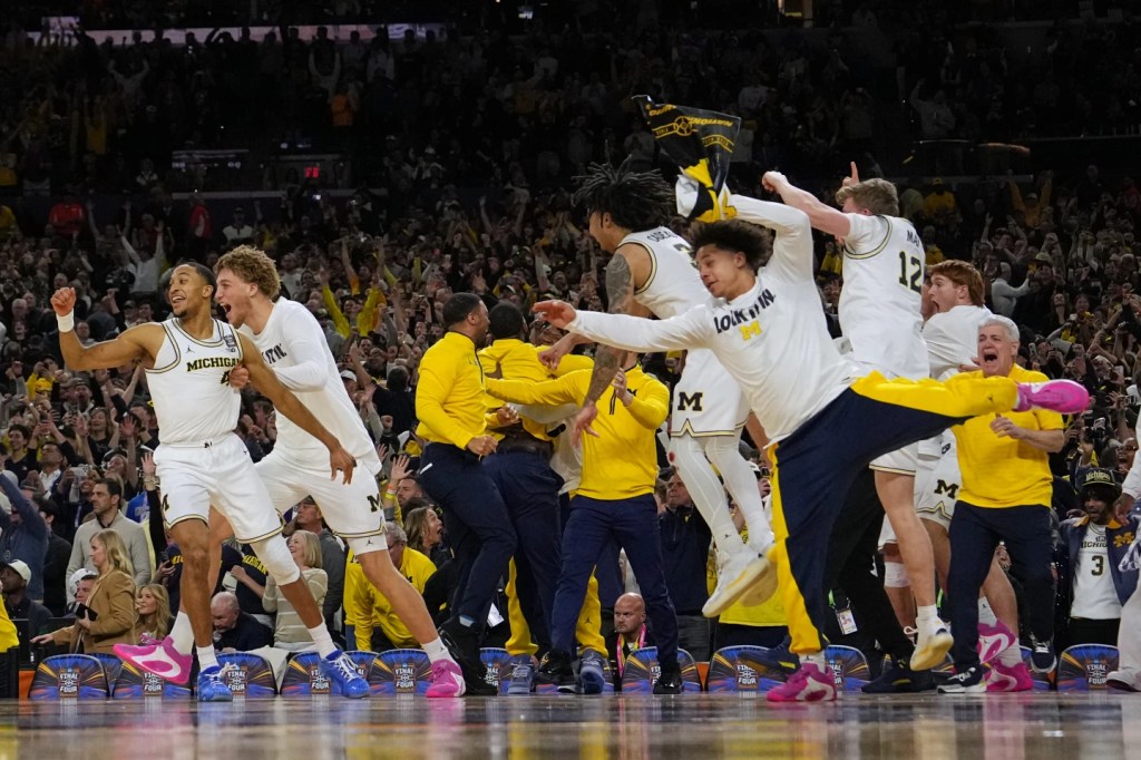 Michigan muscles its way to program’s 2nd national title, beating stubborn UConn 69-63